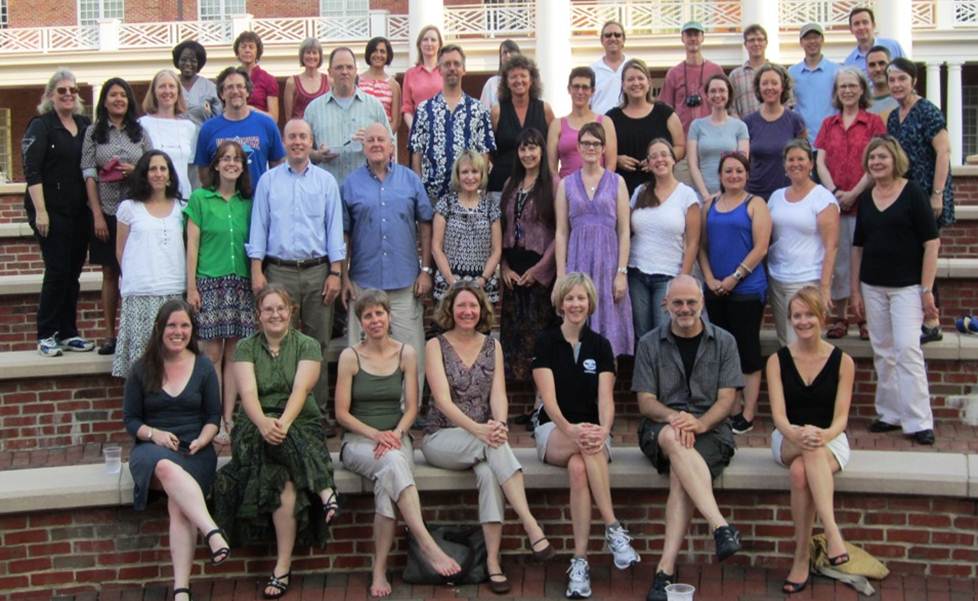 43 participants and leaders from the 2011-2013 research seminar on Critical Transitions: Writing and the Question of Transfer pose for a photo, sitting or standing on 4 levels of an outdoor amphitheater